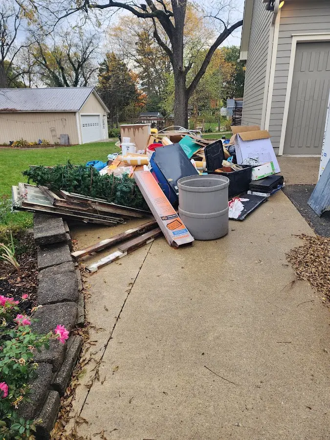 Dumpster being loaded with debris for Roofing Dumpster Rental in Southaven